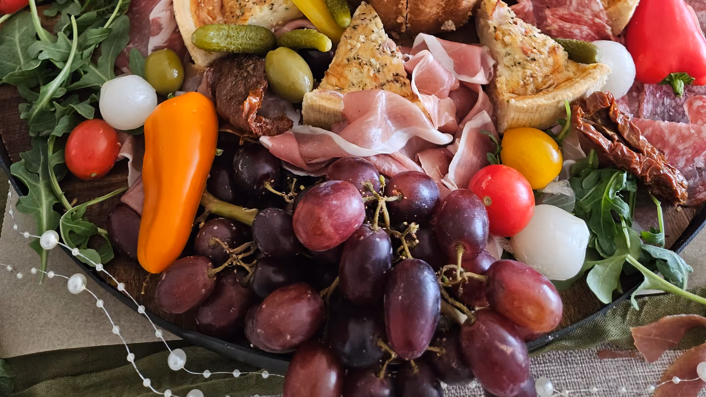 A grazing platter with grapes and charcuterie